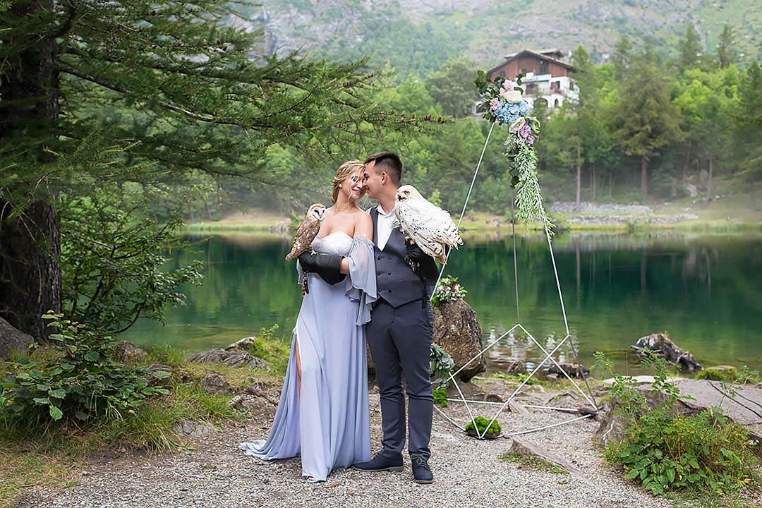 Stylish wedding in the Alps at mountain lake, photoset with an owl title=